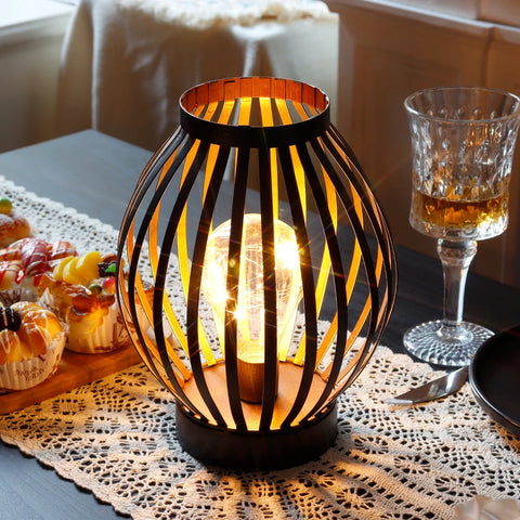 Cordless, battery operated metal cage table lamp for indoor and outdoor use.